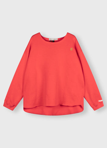 raw edge statement sweater | coral red