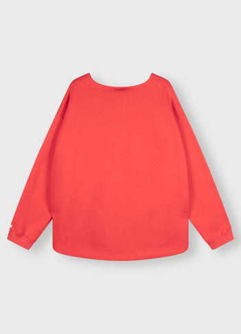raw edge statement sweater | coral red