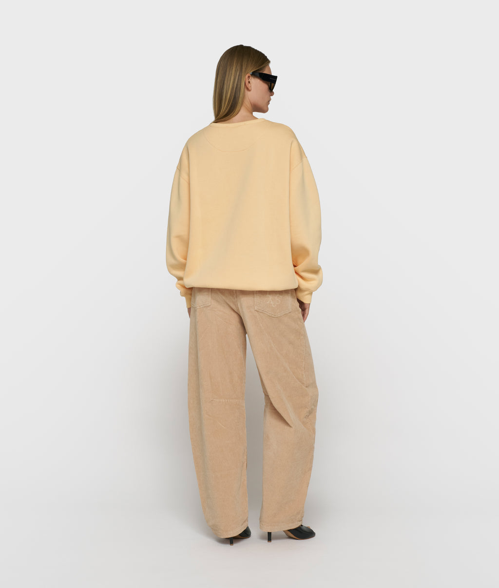 statement sweater met logo | pastel mango