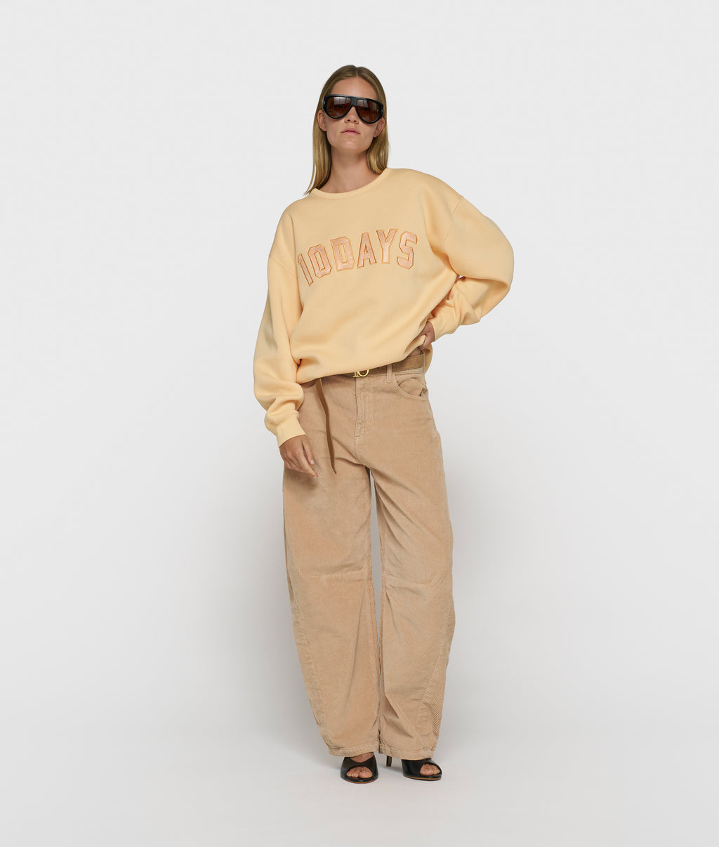statement sweater met logo | pastel mango